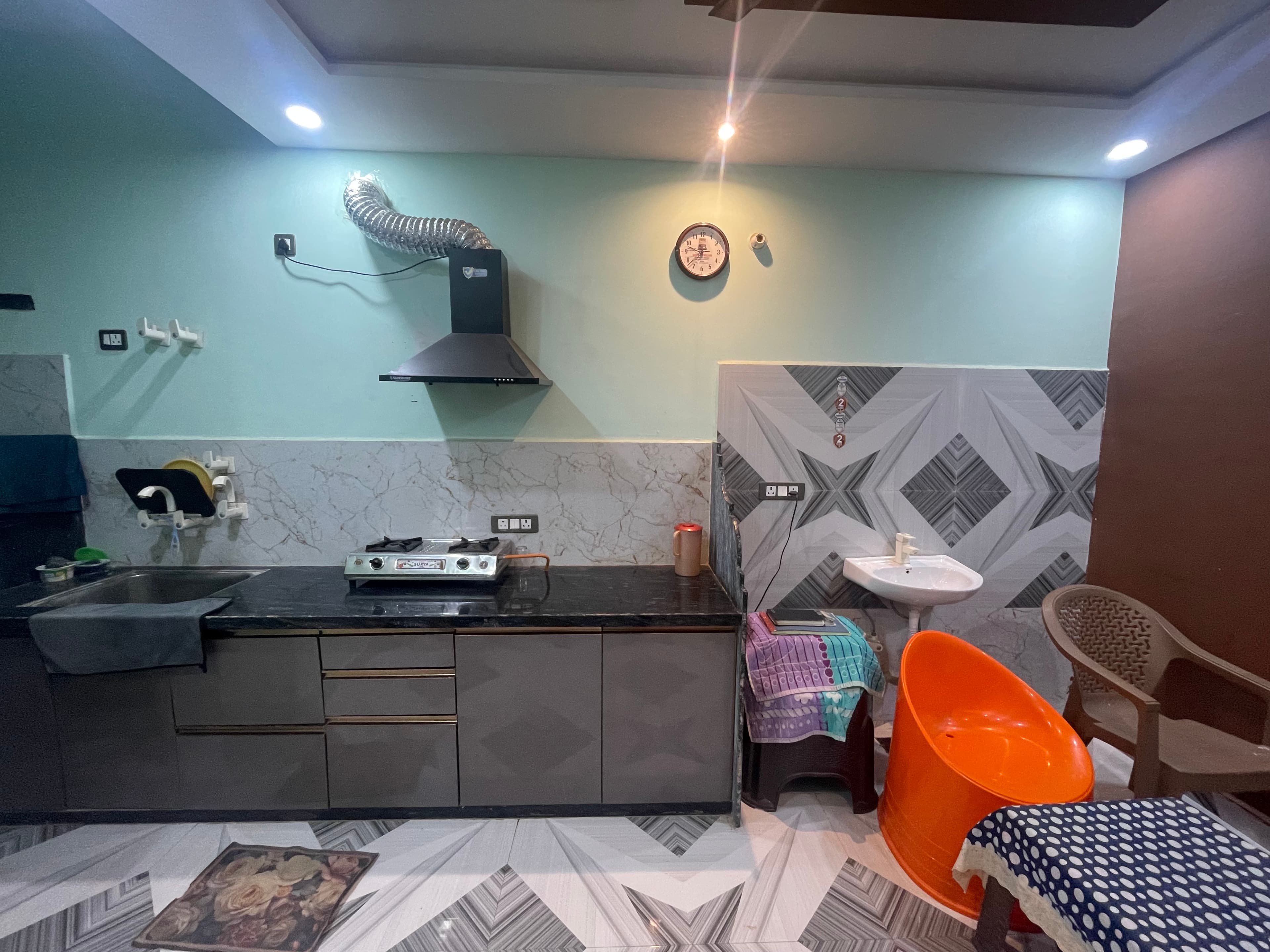 Kitchen counter with gas stove and chimney