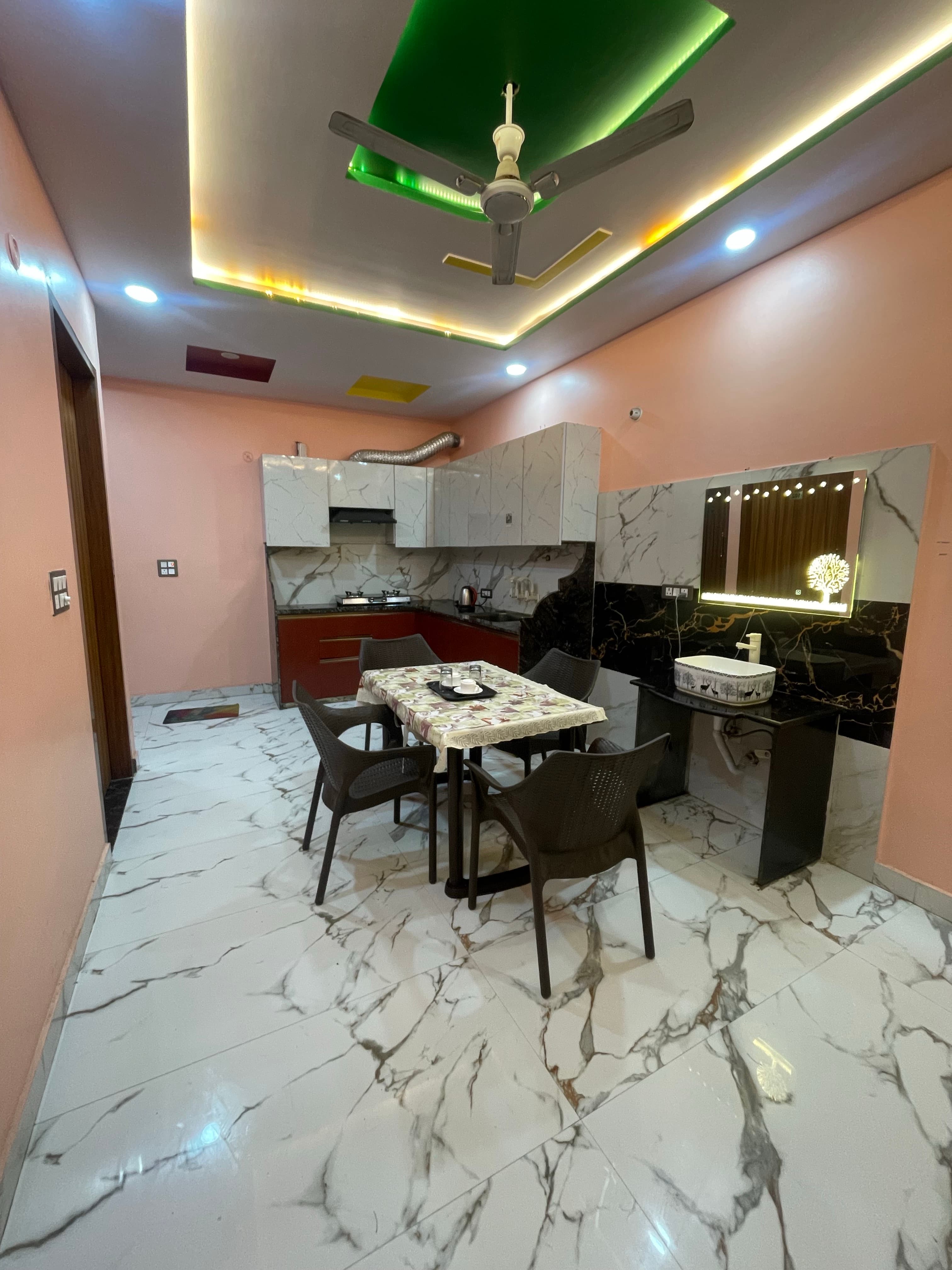 Modular kitchen with overhead cabinets and dining table