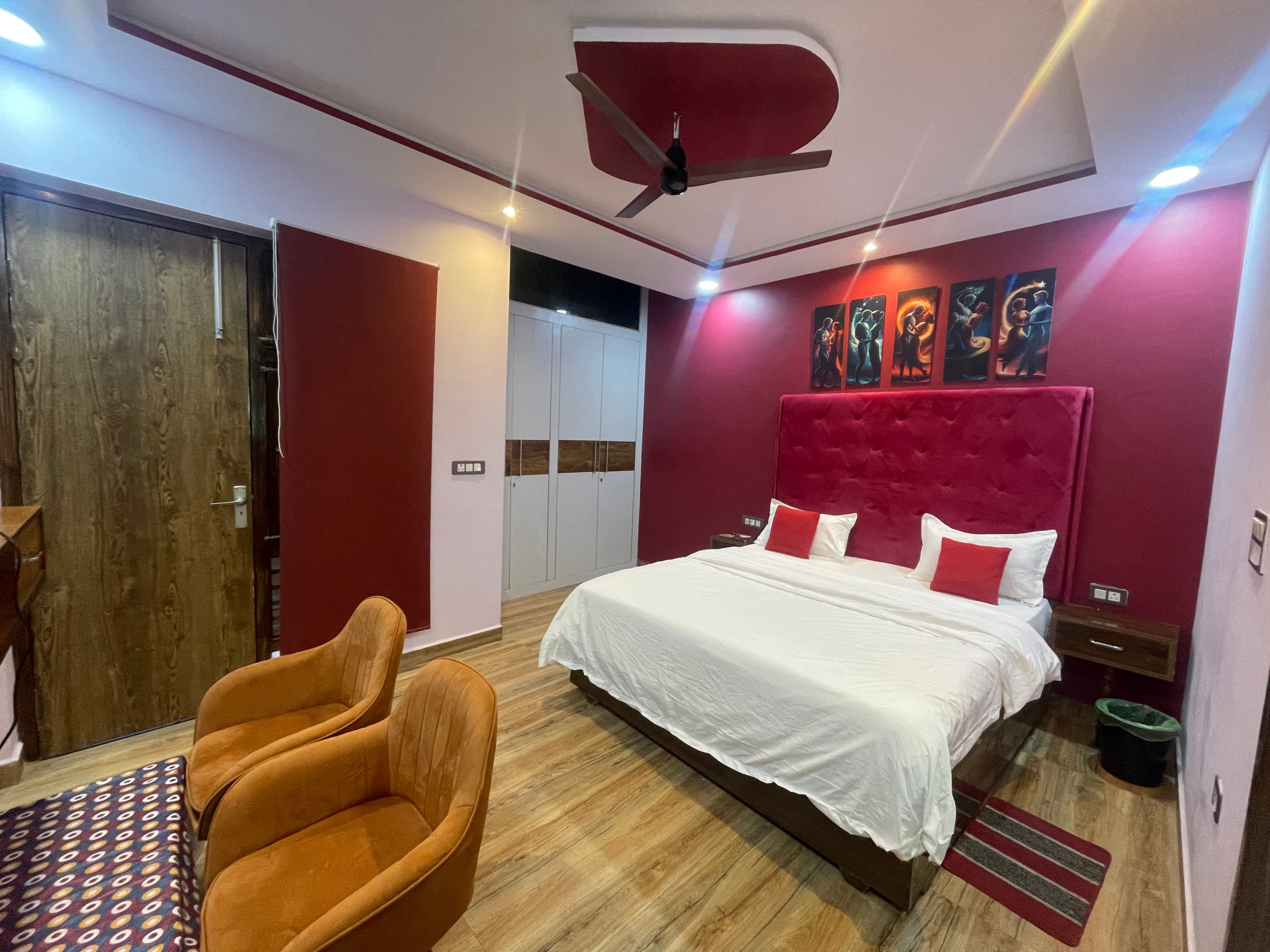 1BHK Private Flat bedroom at VMP Villa โ king bed with red accent wall