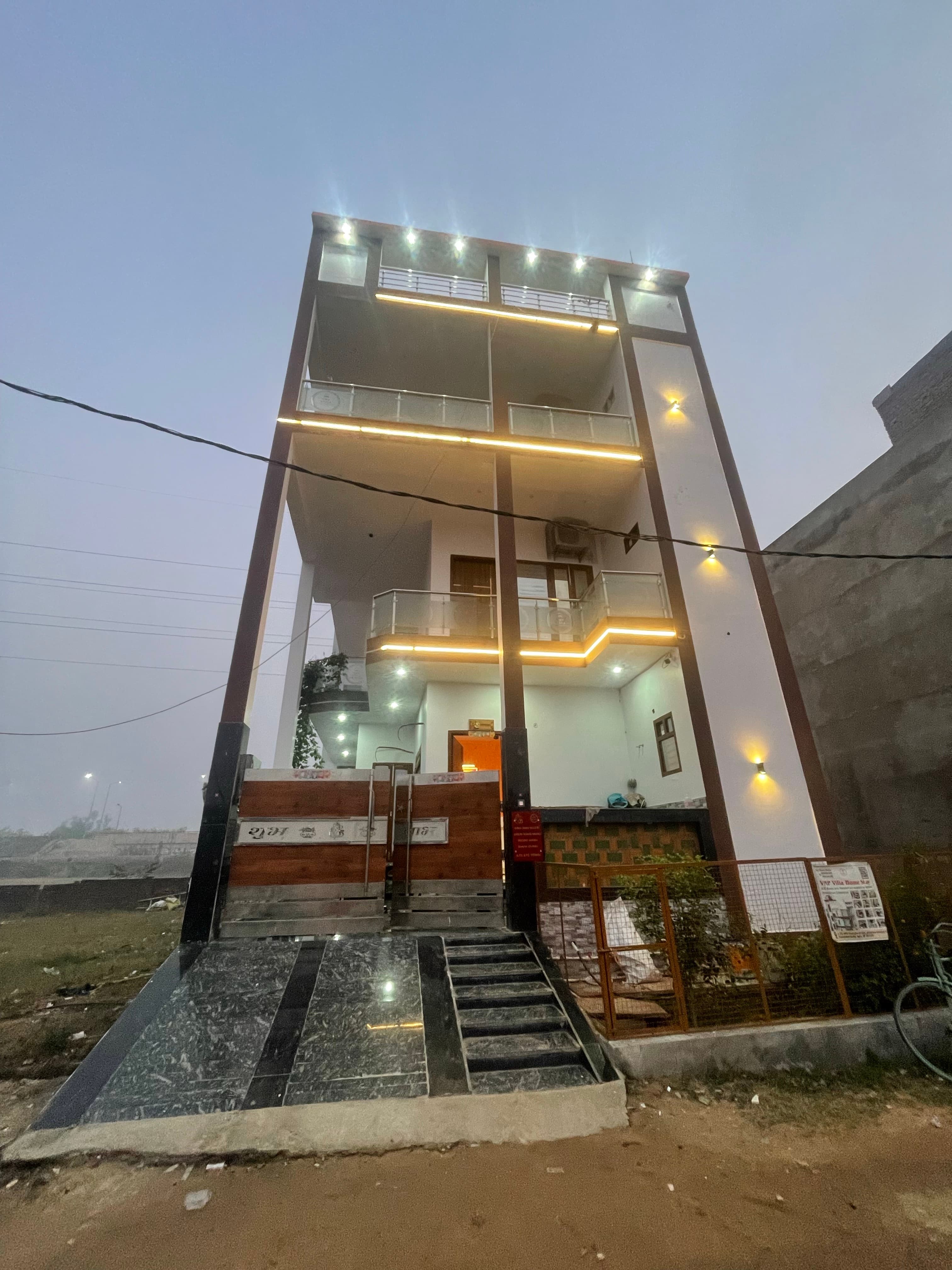 VMP Villa Home Stay building lit up beautifully at dusk, Agra